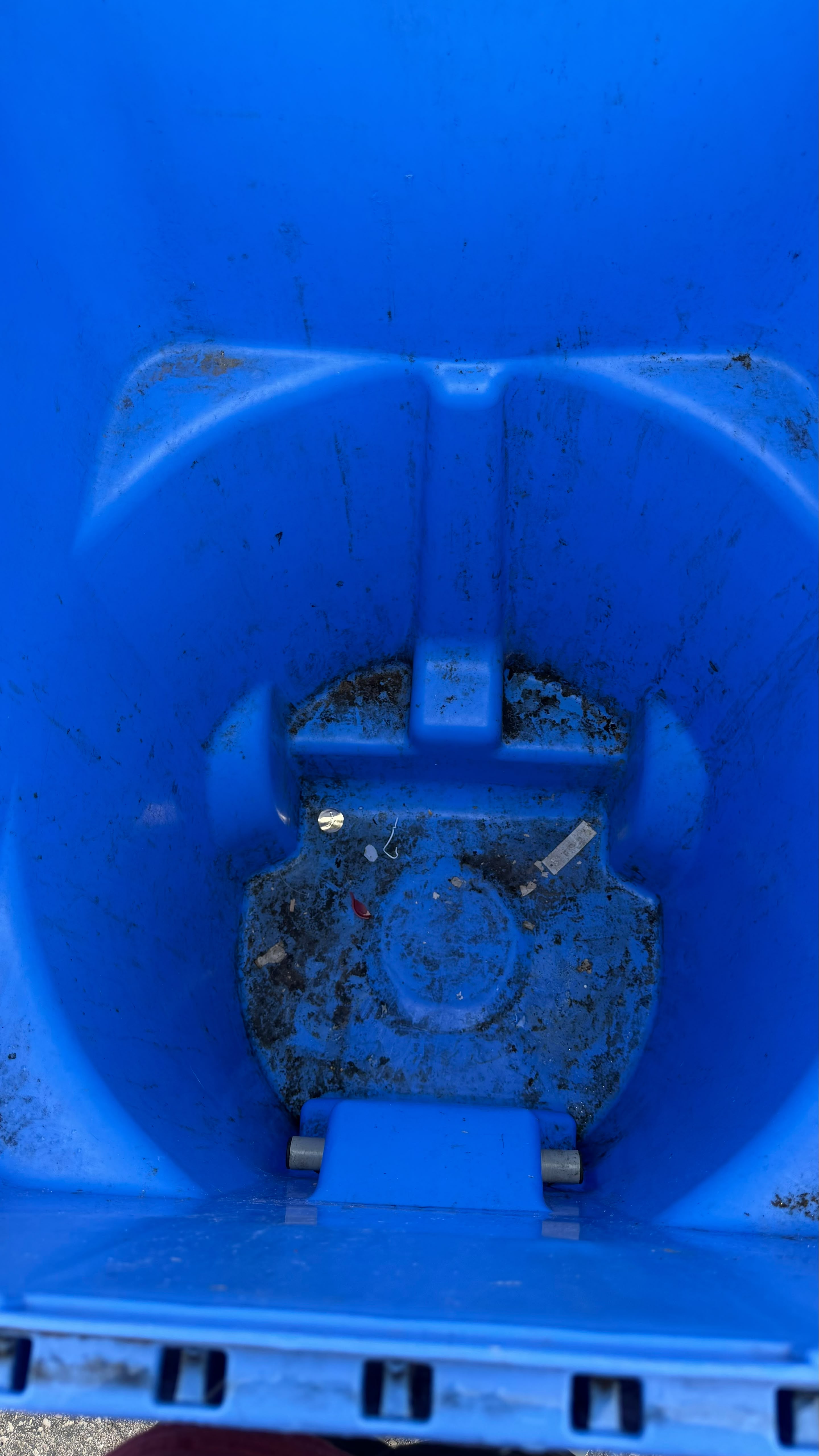 Blue bin with heavy buildup before professional cleaning