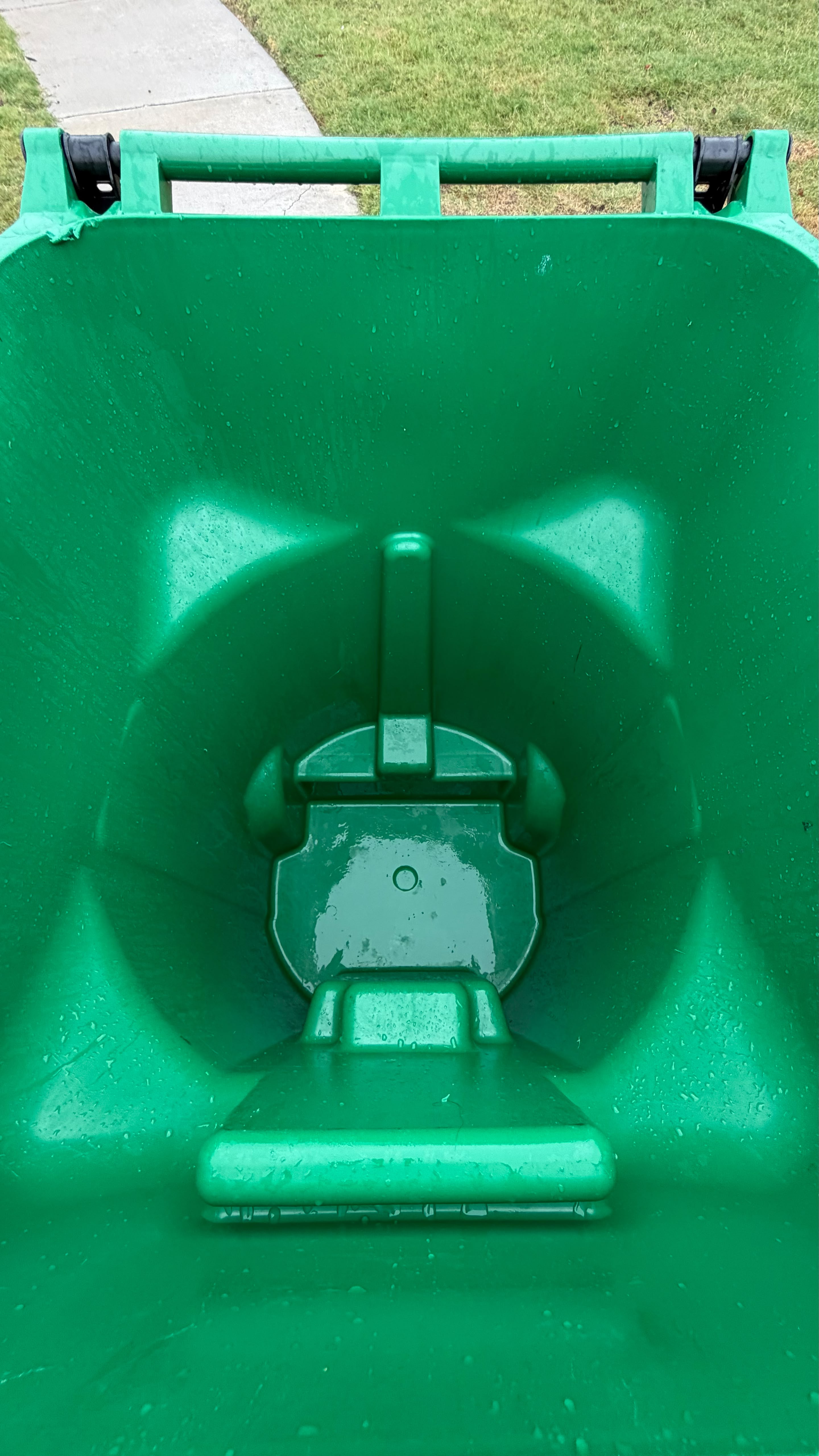 Green trash bin spotless after 200 degree hot pressure wash